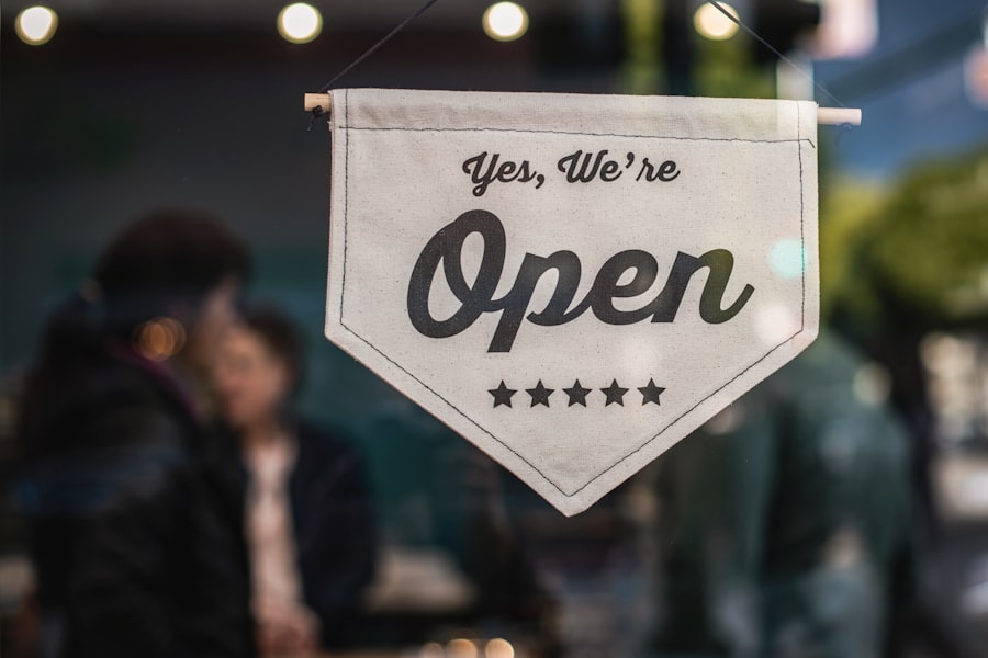 An open sign hanging in a small shop window
